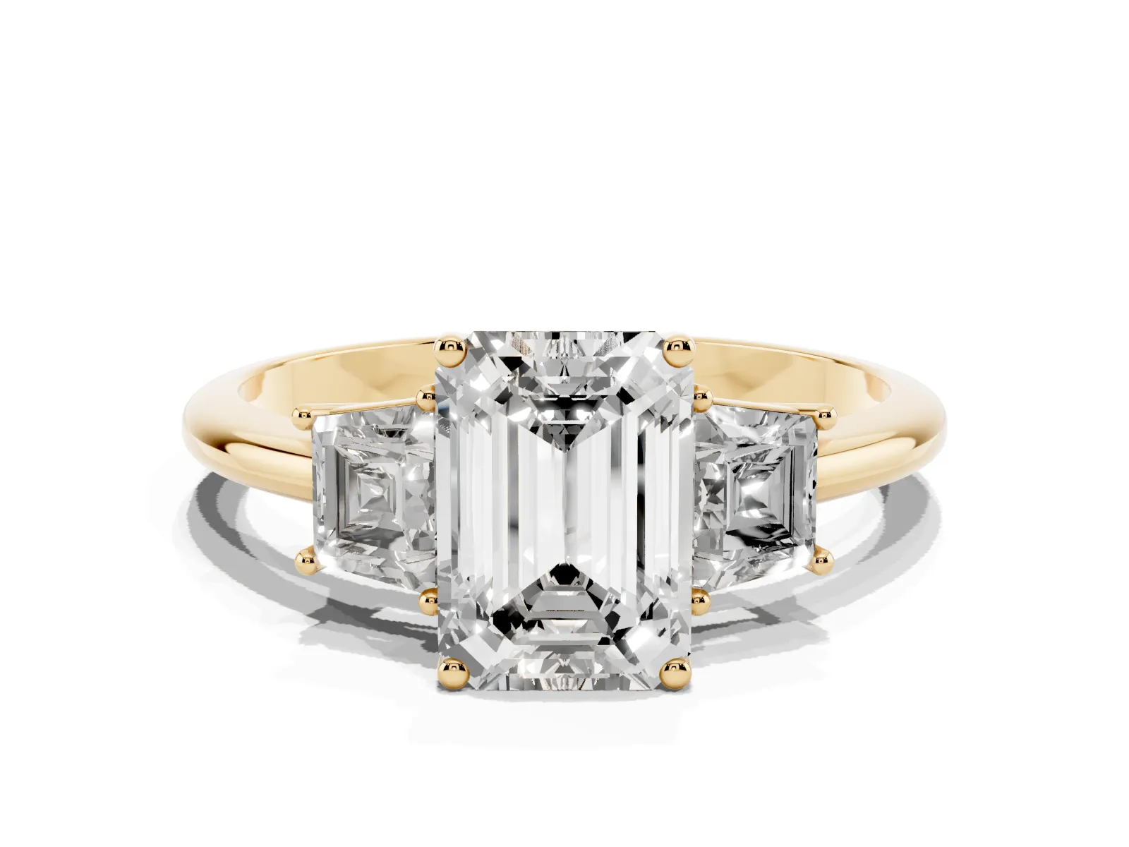 Emerald Cut Diamond Three-Stone Ring with Trapezoid Side Stones and Prong Setting Yellow gold