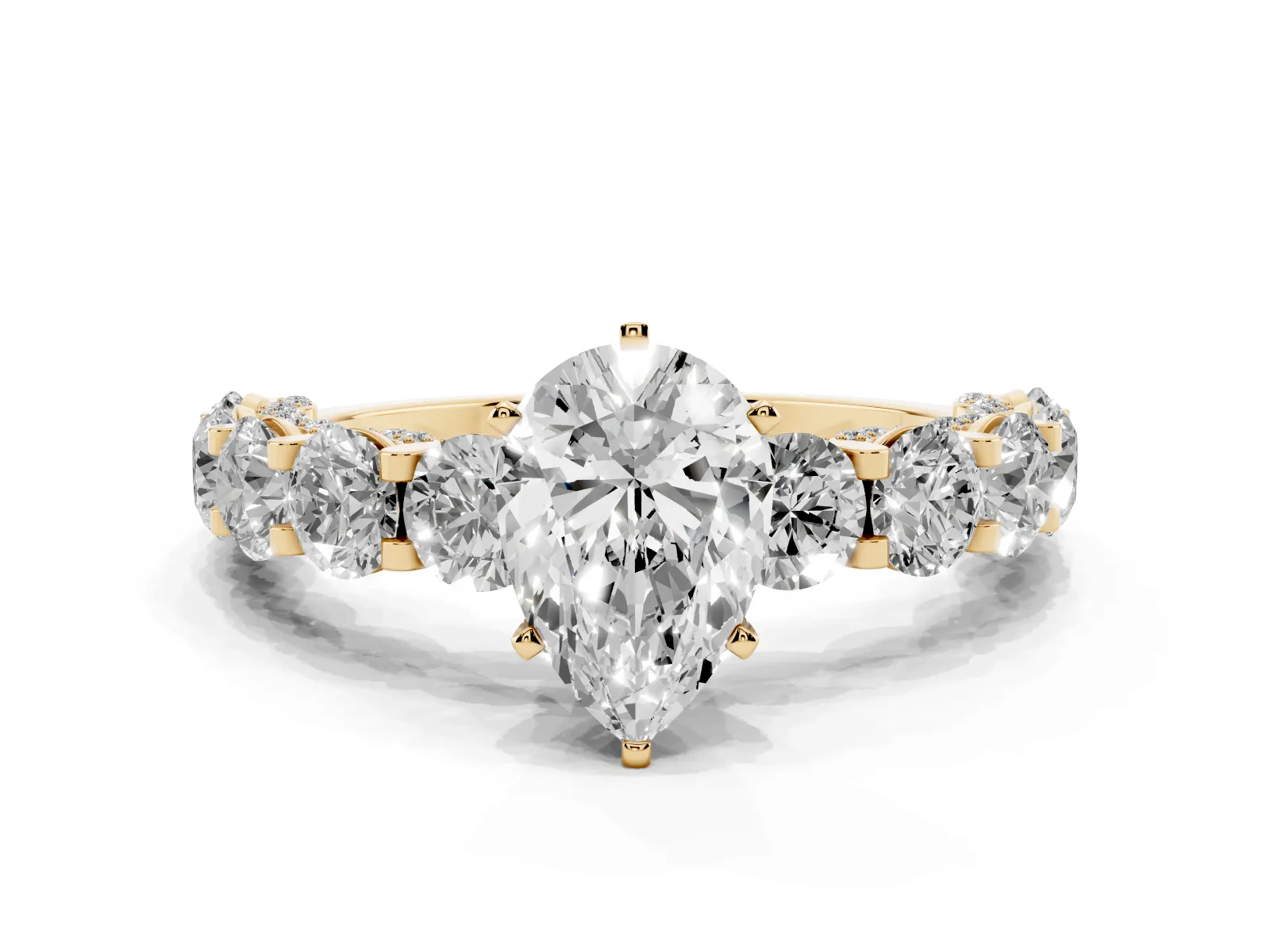 Pear Cut Diamond Side Stone Engagement Ring with Four-Prong Setting Yellow gold