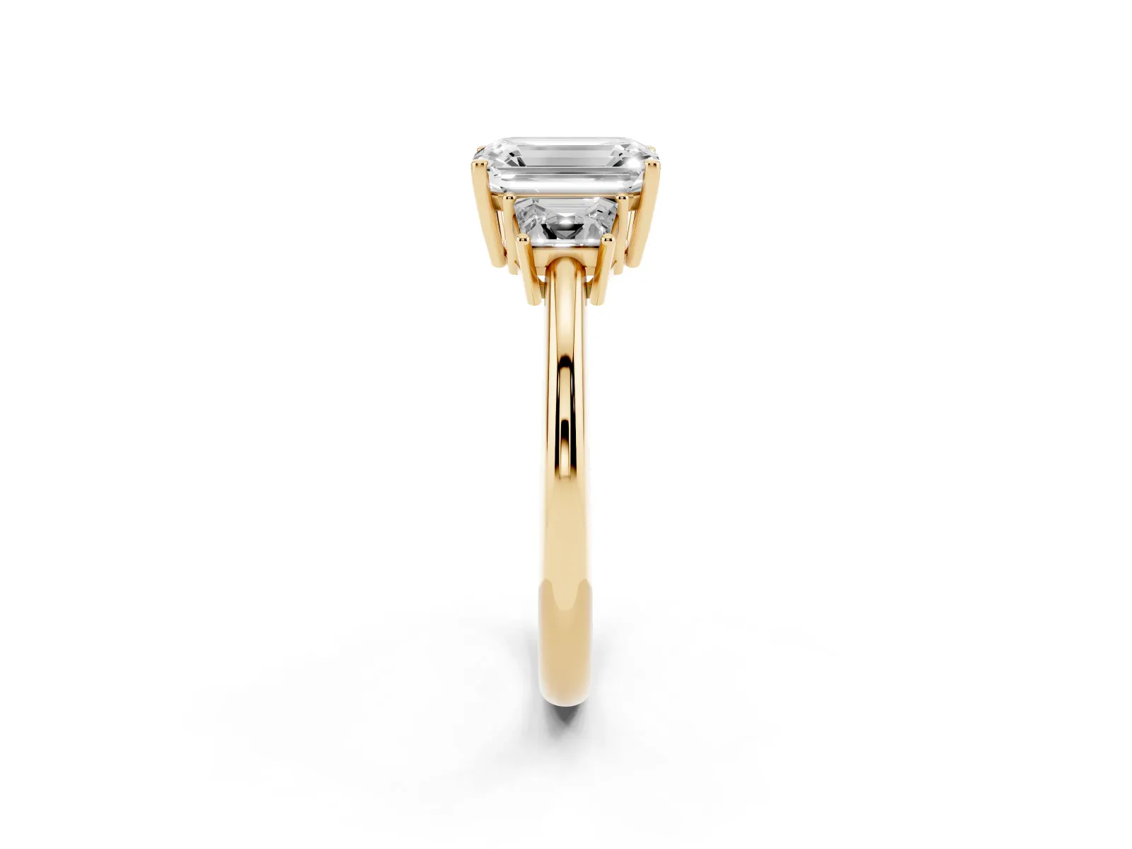 Emerald Cut Diamond Three-Stone Ring with Trapezoid Side Stones and Prong Setting Yellow gold
