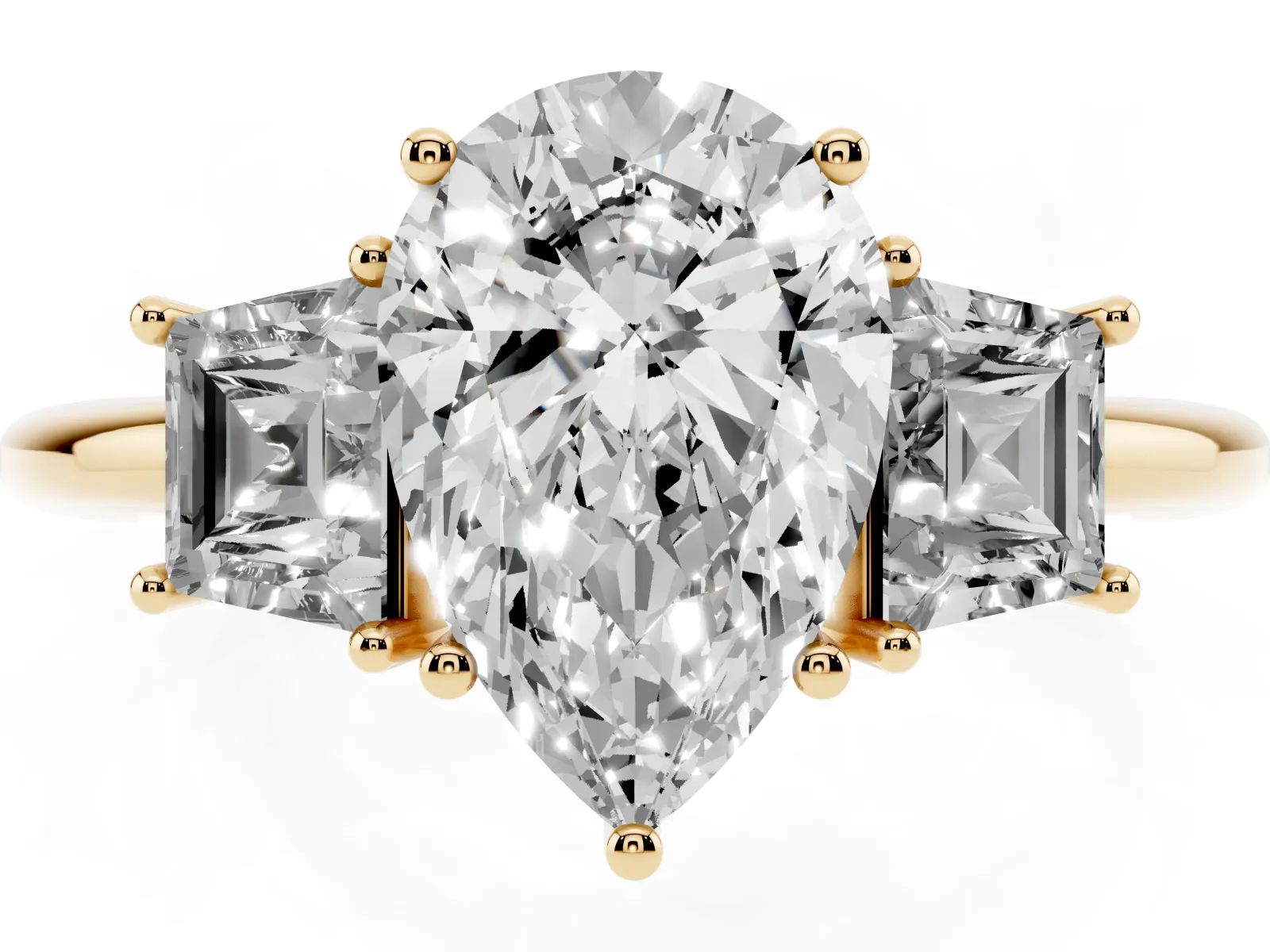 Pear Cut Diamond Three-Stone Ring with Trapezoid Side Stones and Prong Setting Yellow gold