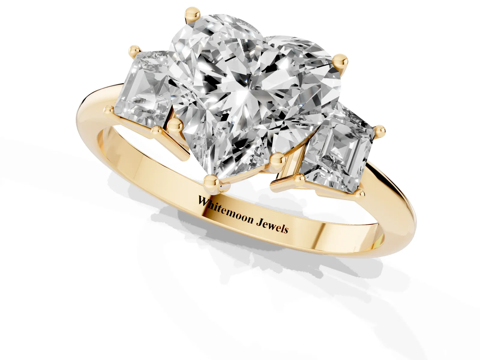 Heart Cut Diamond Three-Stone Ring with Trapezoid Side Stones and Prong Setting Yellow gold