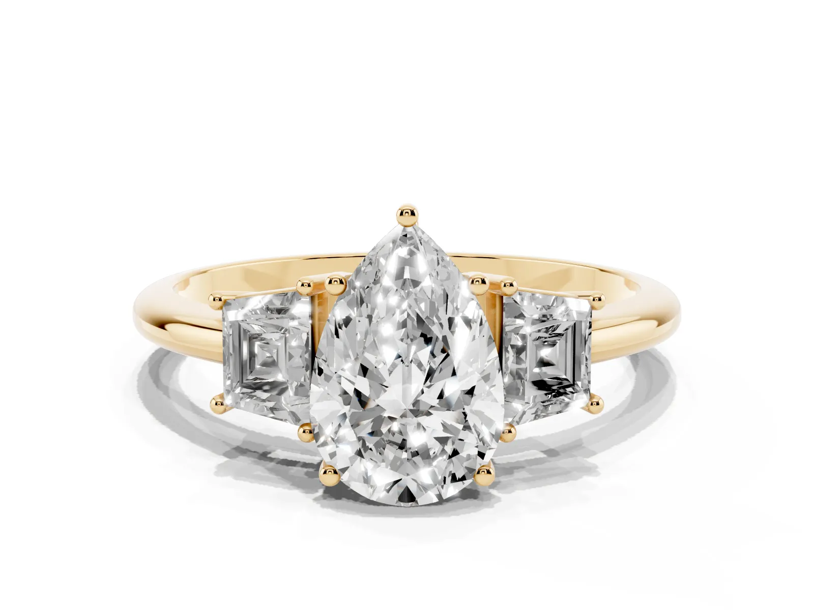Pear Cut Diamond Three-Stone Ring with Trapezoid Side Stones and Prong Setting Yellow gold