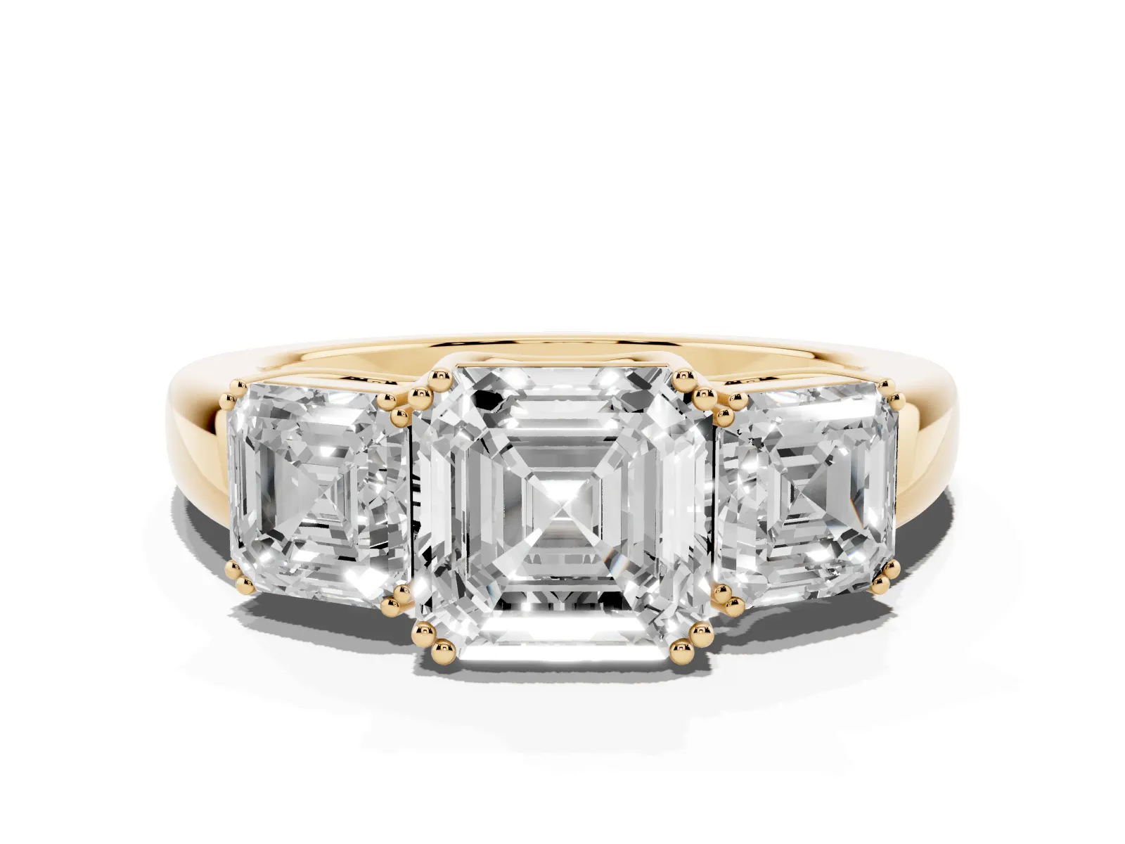 Three-Stone Asscher Cut Cut Diamond Ring with Channel Set Band and Four-Prong Setting Yellow gold